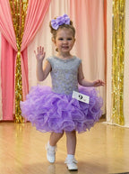Girls lavender beaded ruffle cupcake pageant dress on stage