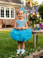 Girls turquoise beaded ruffle cupcake pageant dress outdoors, front view